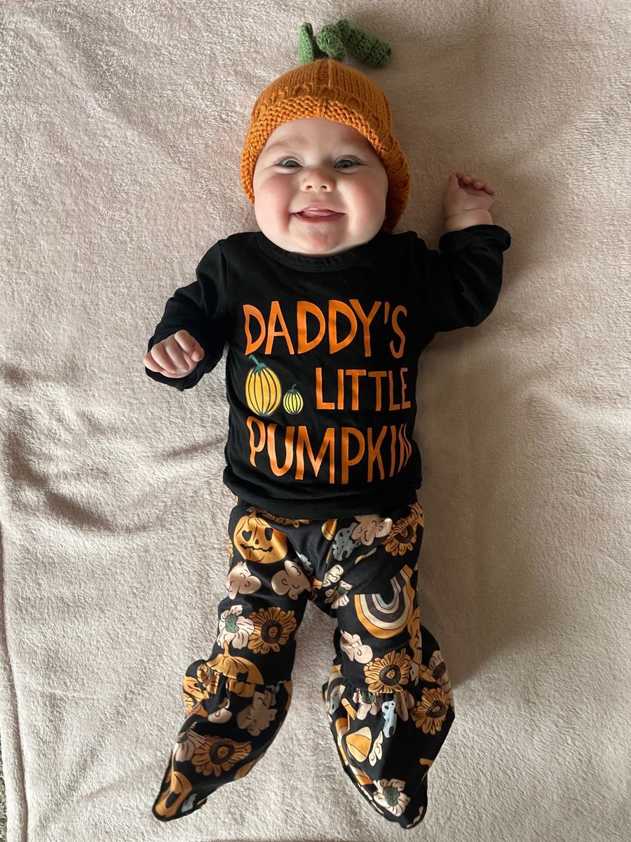 Vivian in her knit pumpkin hat and her Daddy's Little Pumpkin outfit